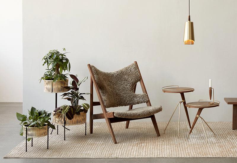 Three Umanoff Planter by Arther Umanoff for Audo Copenhagen displayed with other furniture.