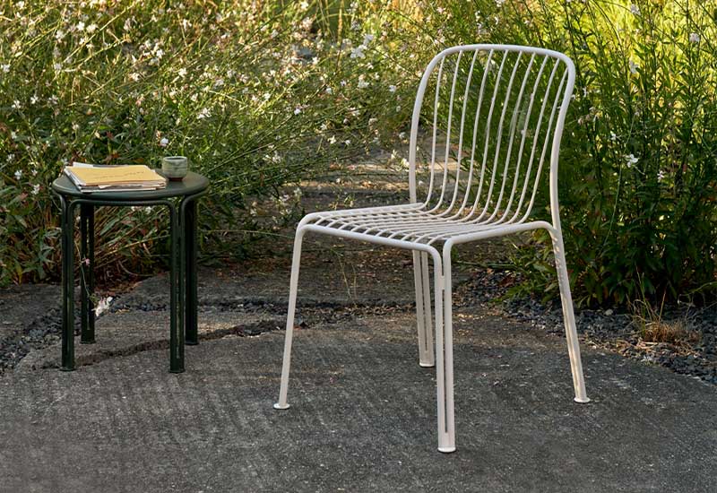The Thorvald Side Chair by Space Copenhagen for &tradition in ivory with a bronze green side table.