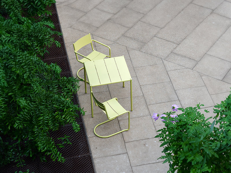 The Sine dining armchair, chair and small table in yellow.