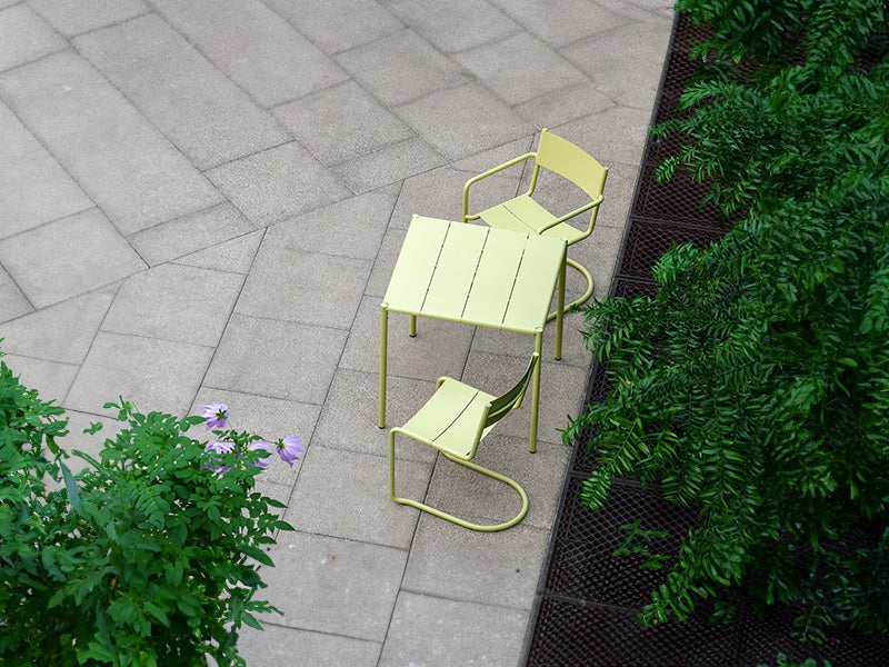The Sine dining armchair, chair and small table in yellow.