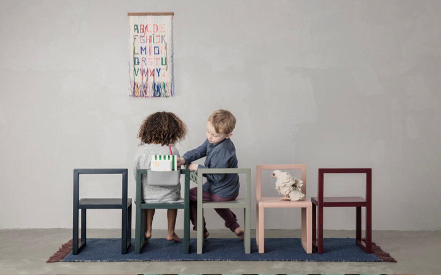 A row of five Little Architect Chairs in dark blue, dark green, grey, rose and bordeaux.