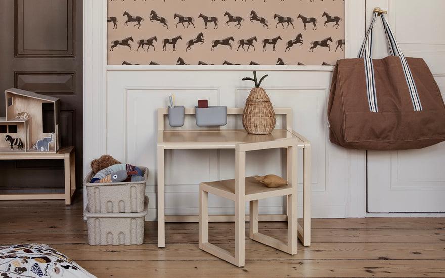  The Little Architect Desk and the Little Architect Chair in cashmere are placed within an interior setting.