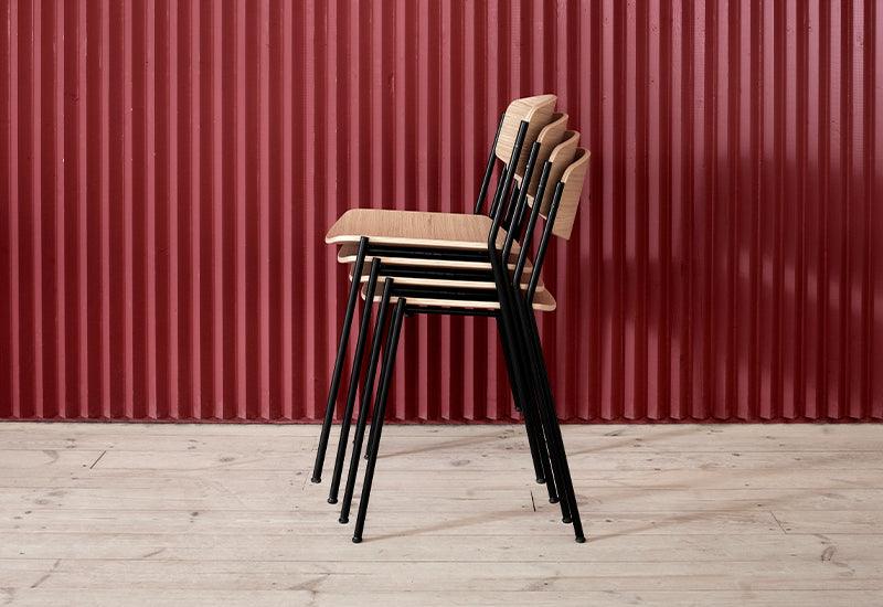 The Lynderup Chair stacked in oak with black lacquered frame, designed by Børge Mogensen for Fredericia.