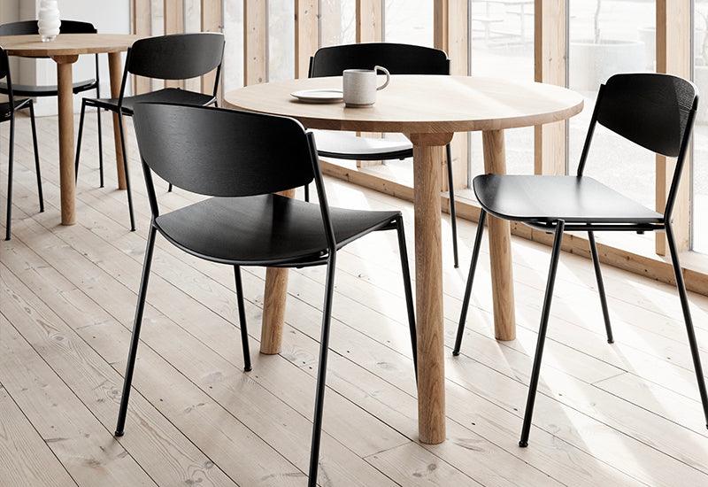 A set of three Lynderup Chairs sat around a table. Designed by Børge Mogensen for Fredericia.