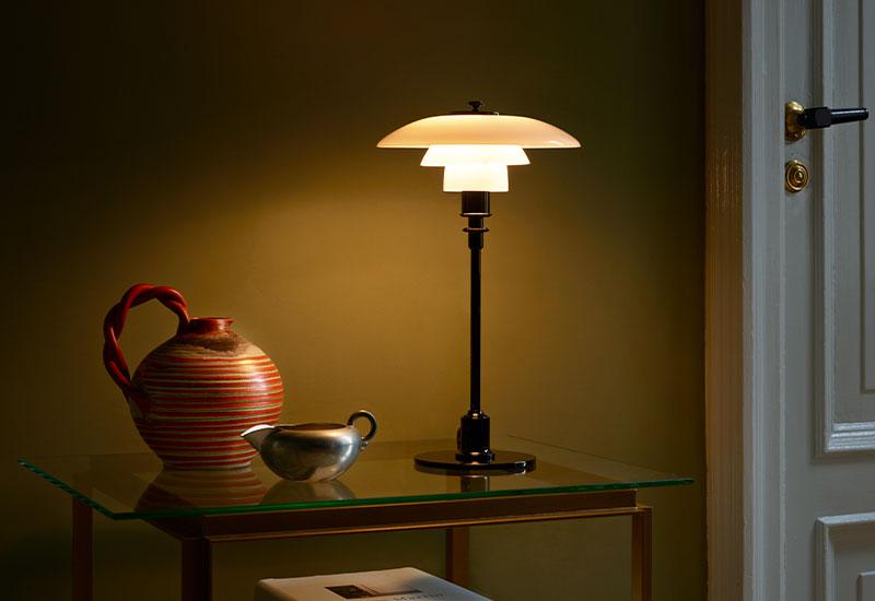 PH 2/1 table light by Poul Henningsen for Louis Poulsen next to a vase.