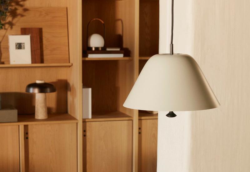 The Levitate Pendant by Afternoon for Menu in grey shade and brass bronze detailing.