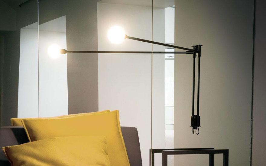 The Mini Potence Pivotante by Charlotte Perriand for Nemo Lighting illuminating a room.