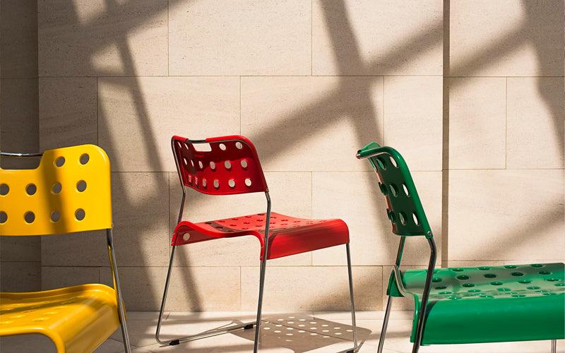 The Omkstak Classic Chair by Rodney Kinsman for OMK 1965 in tomato red, signal yellow and mint green.
