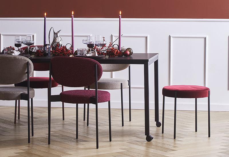 The Series 430 stool, by Verner Panton for Verpan at the head of a table.