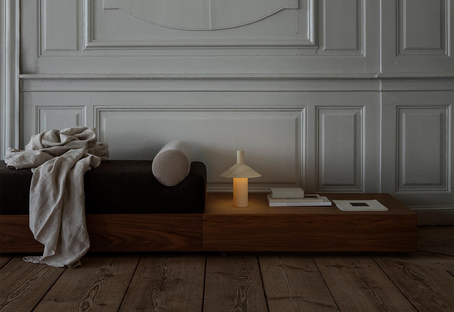 -astep pepa table light in natural oak finish on a side table