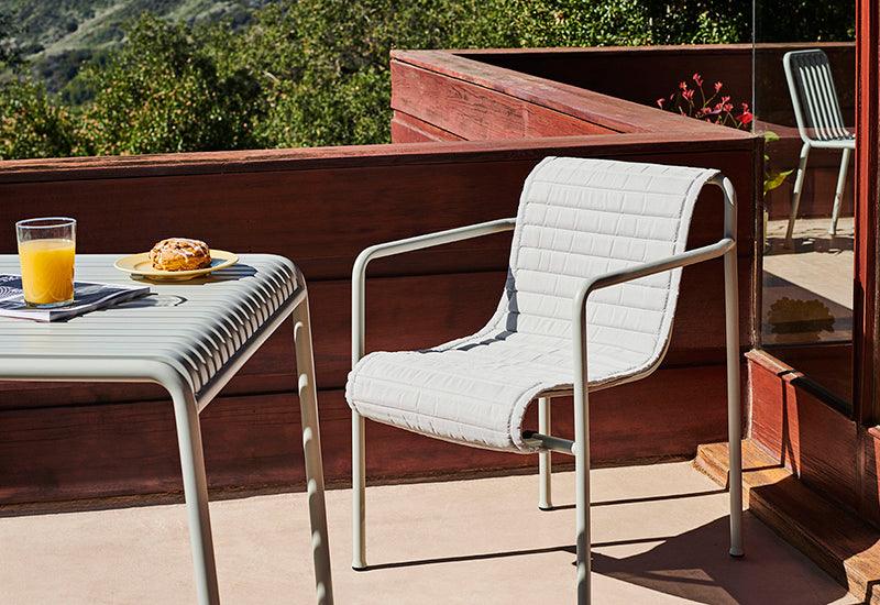 Palissade armchair from HAY, on a balcony.