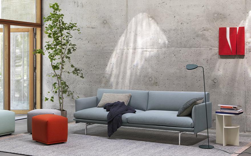 Outline three seater sofa by Anderssen + Voll for Muuto, in Steelcut Trio 713 upholstery, in living space with red accents.