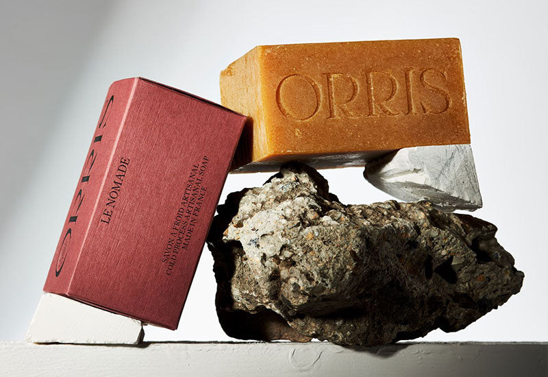 Le Nomade Soap by ORRIS balanced on a rock.