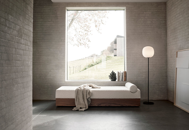 New Works Lantern floor lamp in Medium size next to a daybed