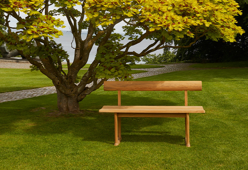  Fritz Hansen Banco bench by Hugo Passos under a tree