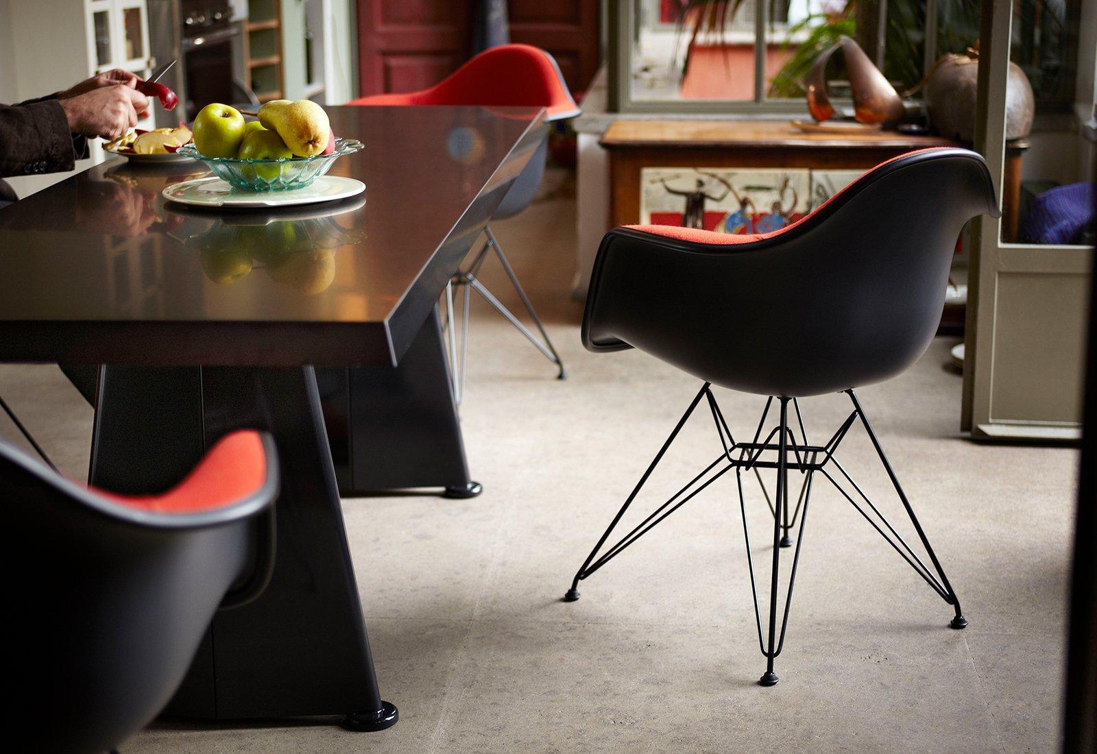  Eames DAR Armchair by Charles + Ray Eames for Vitra in black with red upholstery.
